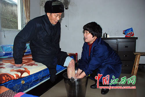 吳菊連(右)在給敬老院的老人洗腳